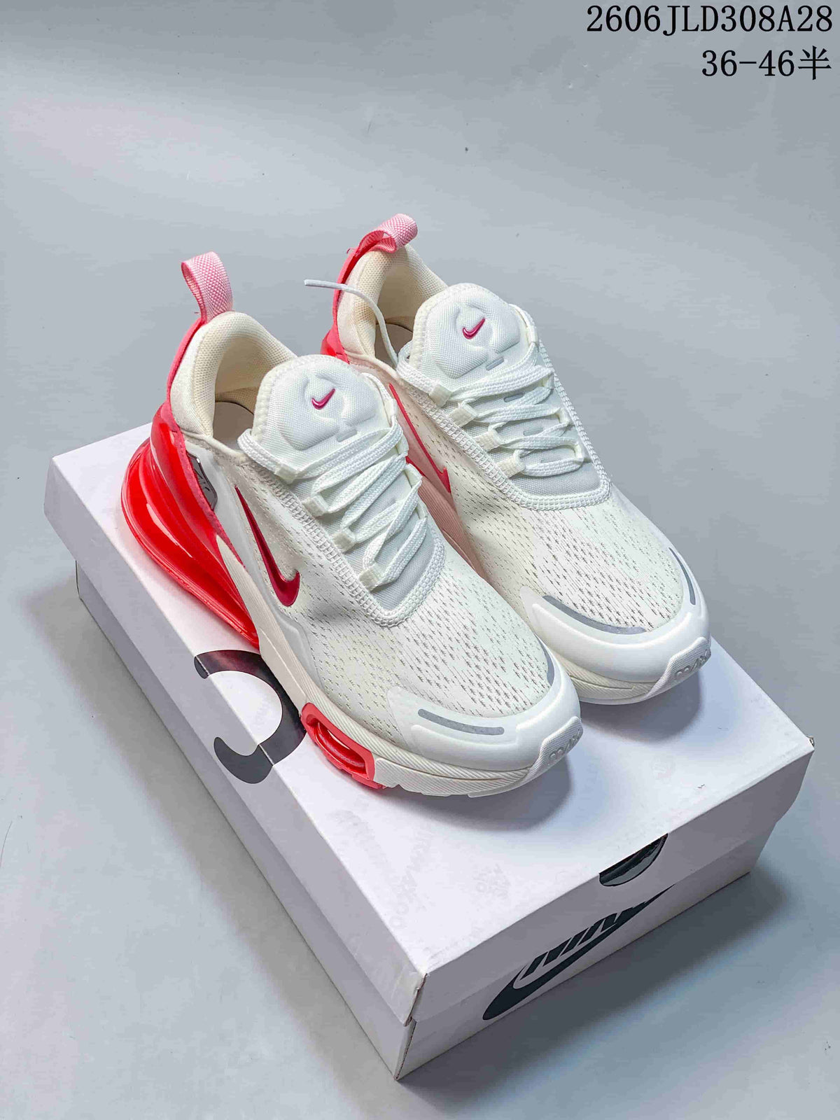 Pair of white and red Nike Air Max 270 Premium sneakers on a shoebox