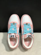 Top-down view showing the white perforated toe boxes, light-blue laces, and pink overlays.