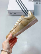 Side profile of the tan low-top sneaker with tonal stitched panels and a gum-colored sole.