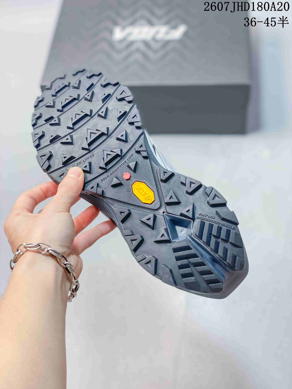 Close view of the rugged outsole with multidirectional lugs and a visible Vibram logo.