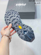 Close view of the rugged outsole with multidirectional lugs and a visible Vibram logo.