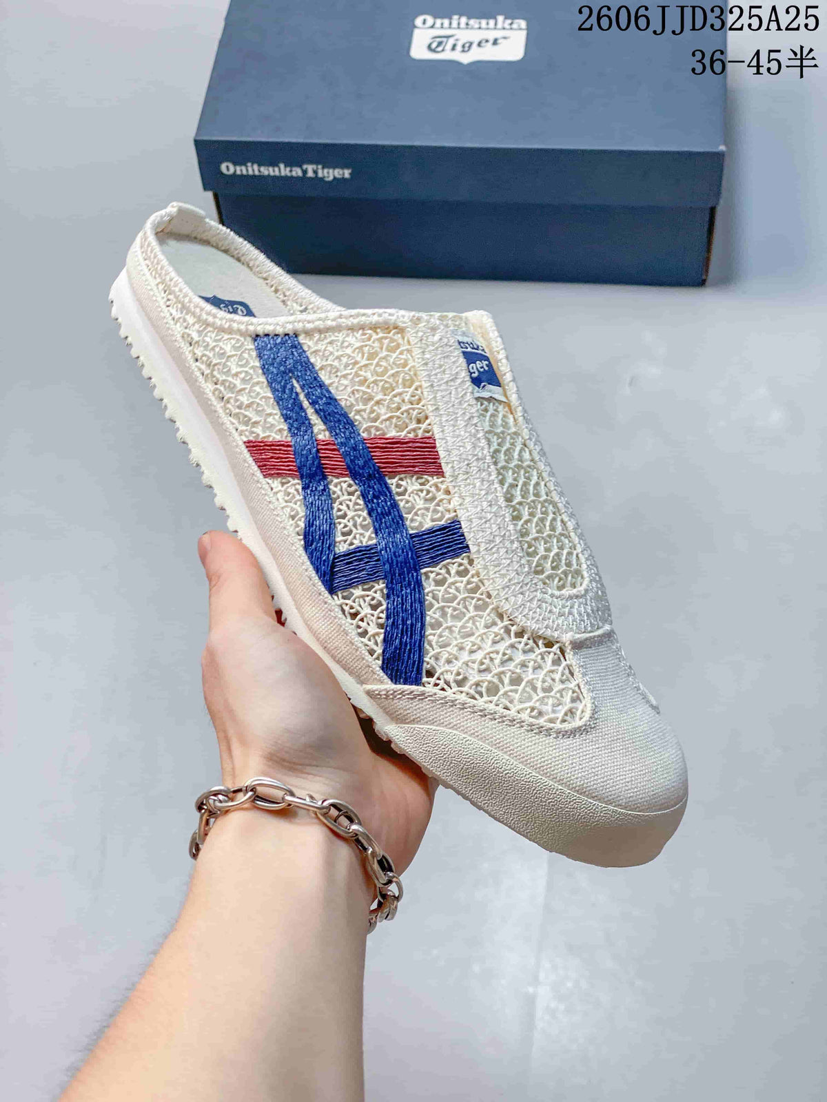 Angled side view of the cream Onitsuka Tiger Mexico 66 Sabot sneaker with blue and red stripes.