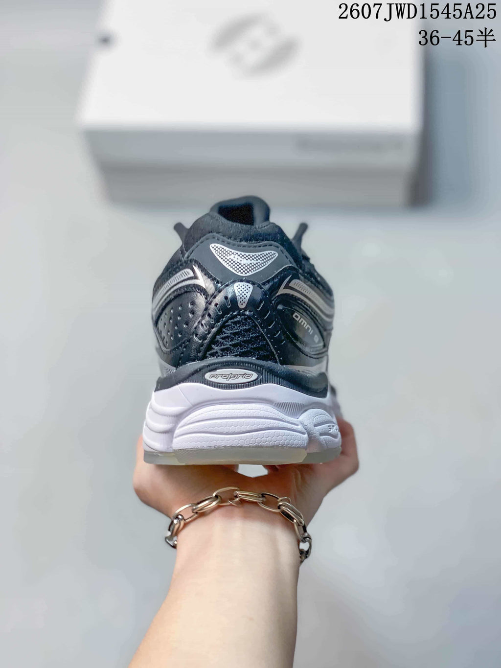 Rear view of the Saucony ProGrid Omni 9 sneaker showing the padded heel, layered details and sculpted white sole.