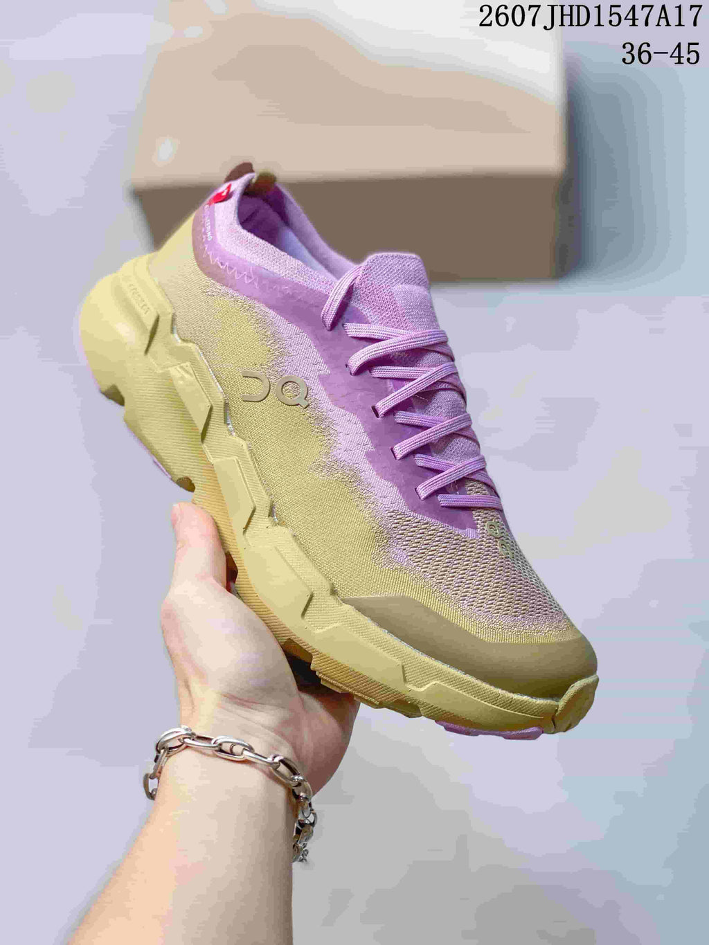 Angled side view of the pink and yellow On CloudSoma sneaker showing the mesh-style upper, laces, branding, and lugged outsole.