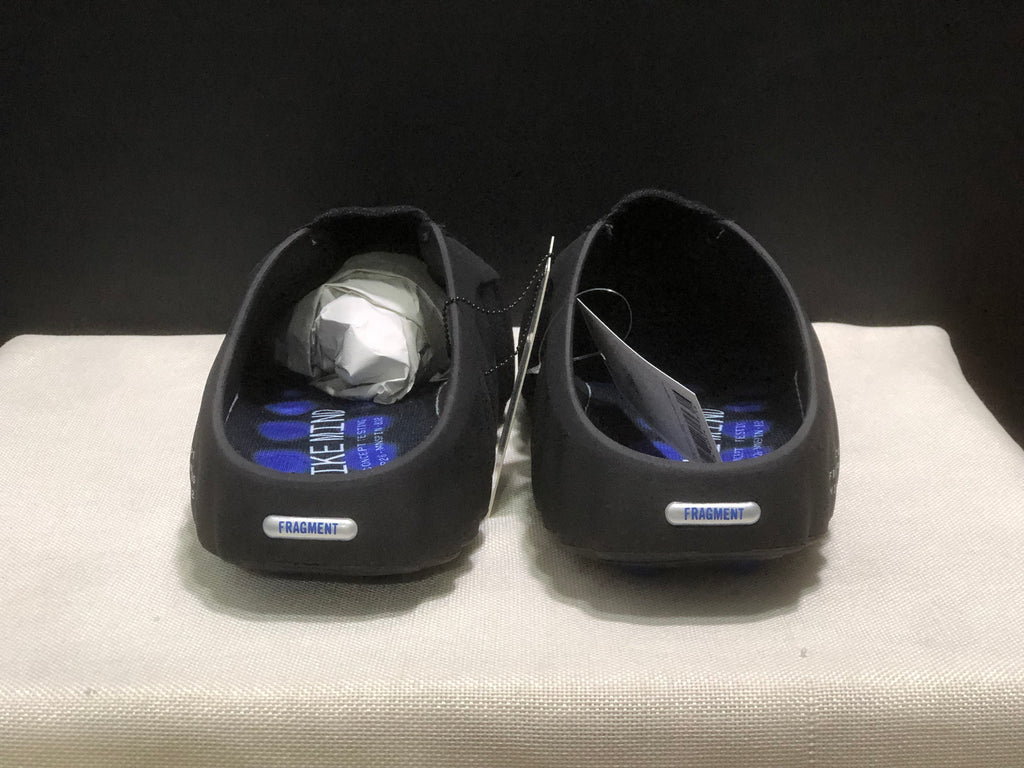 Front view of the pair showing the open heel, black upper, and small Fragment branding details.