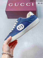 Side view of a blue sneaker with mesh panels, suede-look overlays, and embroidered emblem