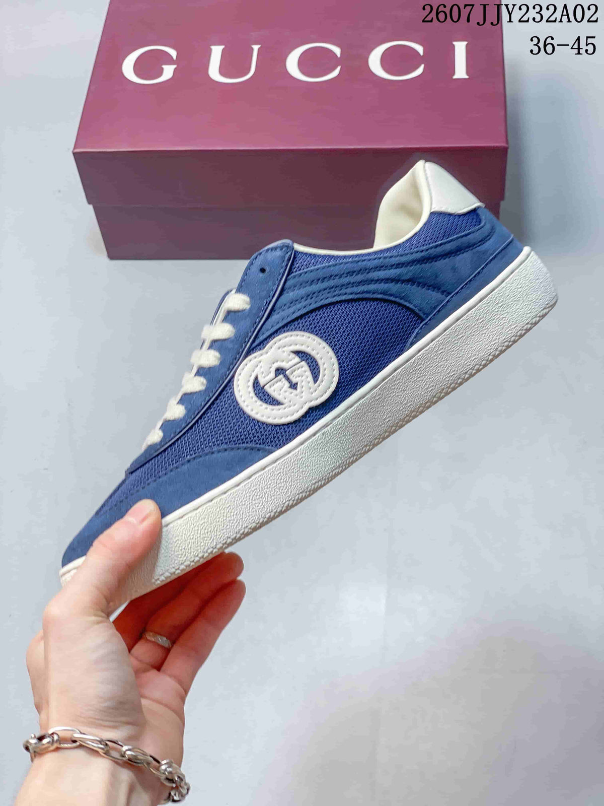 Side view of a blue sneaker with mesh panels, suede-look overlays, and embroidered emblem