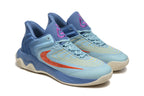 Pair of blue basketball shoes with light blue panels, orange-red accents, and purple tongue logos