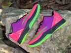 Overhead side view of the pair with textured uppers and green soles