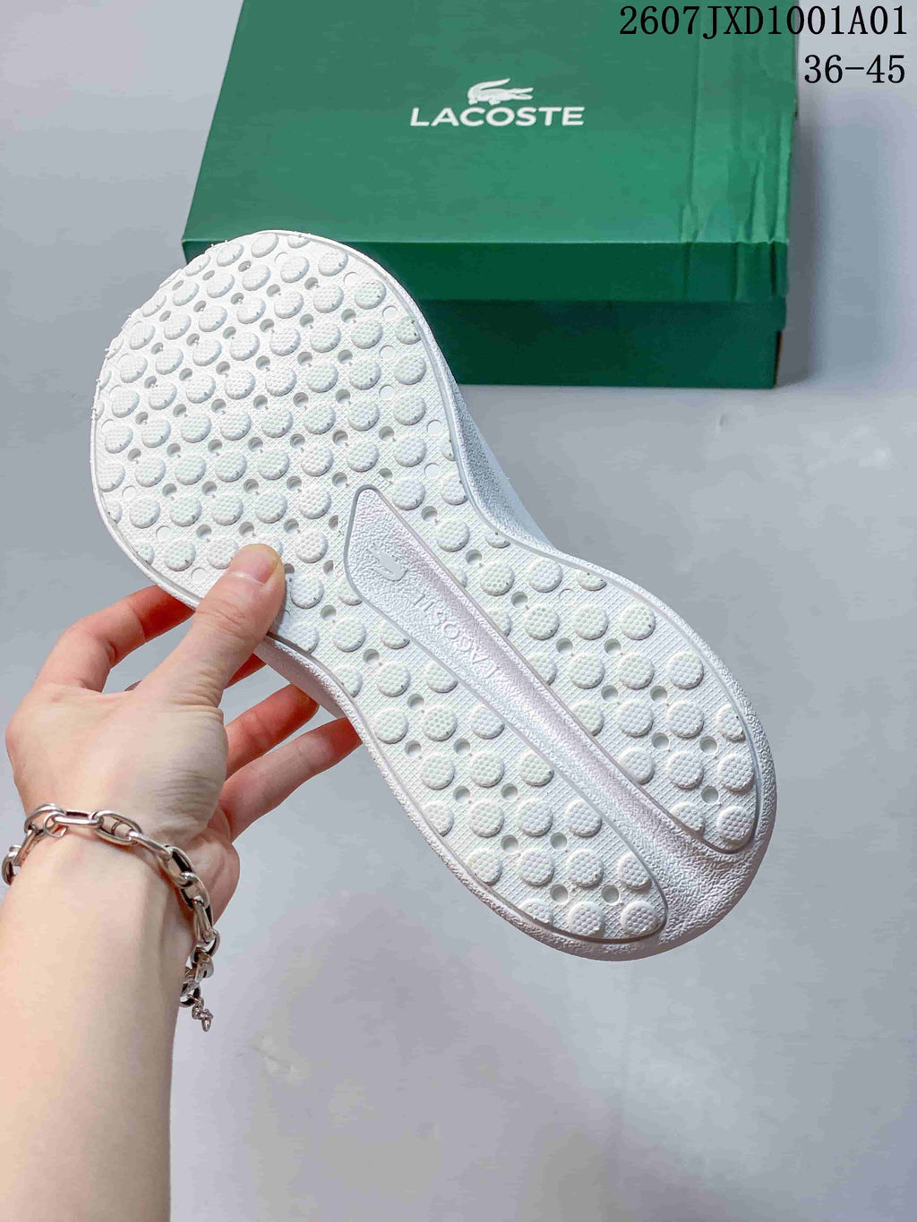 Close-up of the patterned textured outsole of a white sneaker