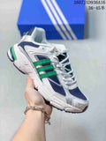 White and navy adidas Response CL sneaker with bright green side stripes, shown against a blue shoe box.