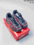 Pair of dark gray and black Nike Air Max TL 2.5 sneakers with red accents, shown on a red shoebox.