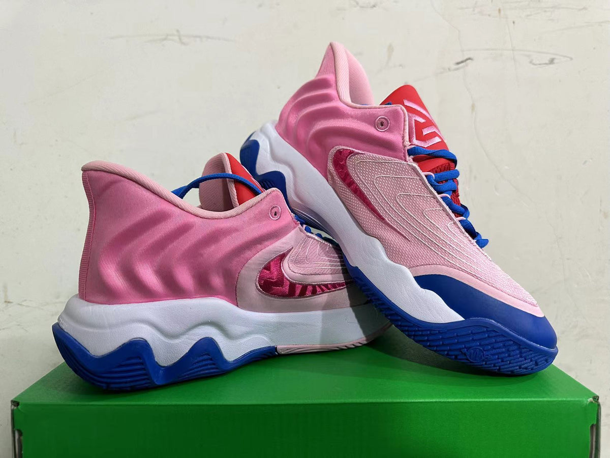 Pair of pink Nike basketball shoes showing the side panels, blue laces, and contrasting soles.