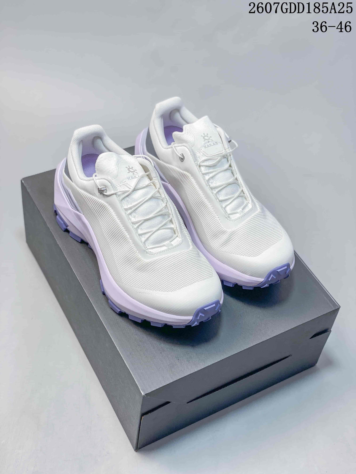 White KAILAS VENTO sneakers with pale purple outsole accents displayed on a black shoebox.