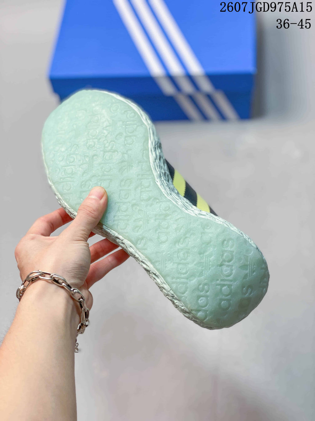 Close-up of the pale textured outsole showing its repeating molded pattern.