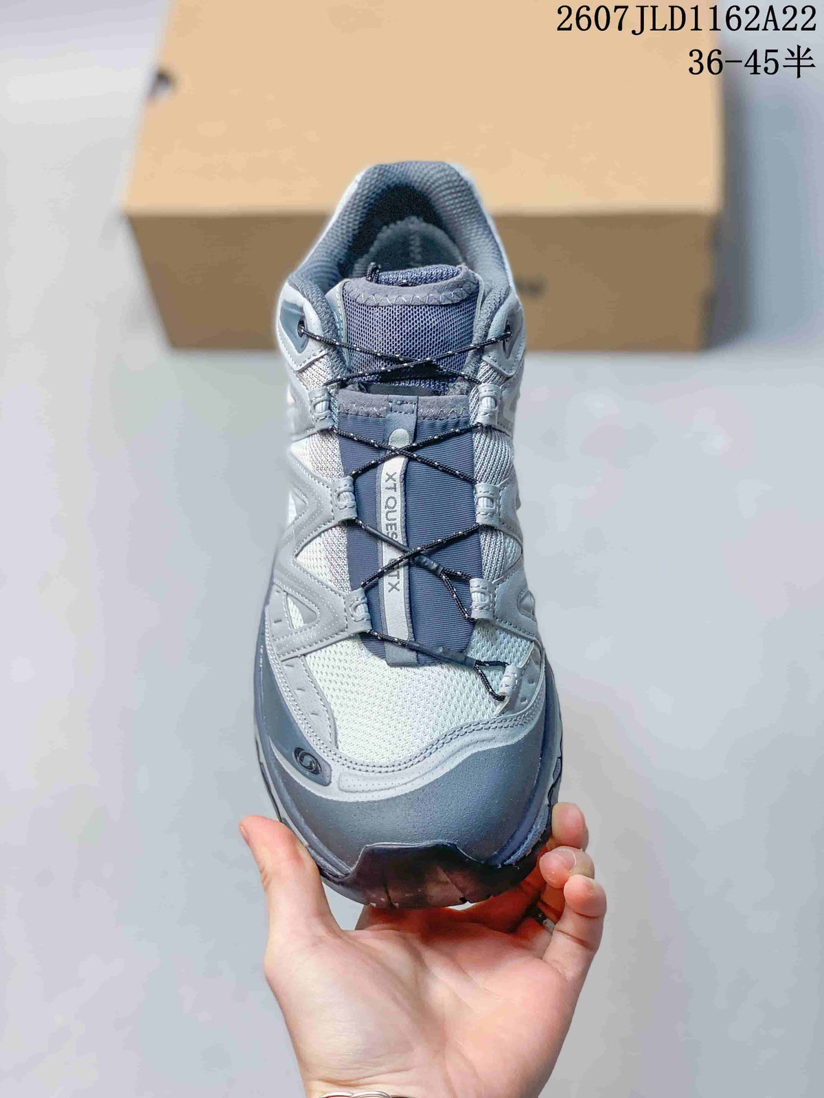 Front view showing the mesh-style toe area, crossed lace system and XT-QUEST tongue detail.