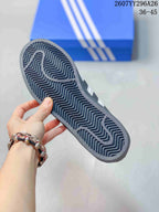 Close view of the dark patterned rubber outsole with zigzag tread and adidas branding.