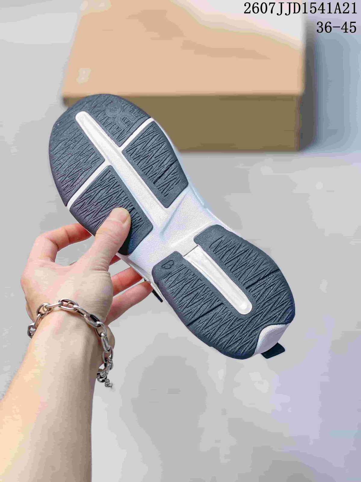 Outsole view showing the black-and-white segmented tread pattern of the sneakers.