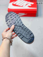 Black outsole of the Nike Air Max 1 sneaker showing its patterned tread.