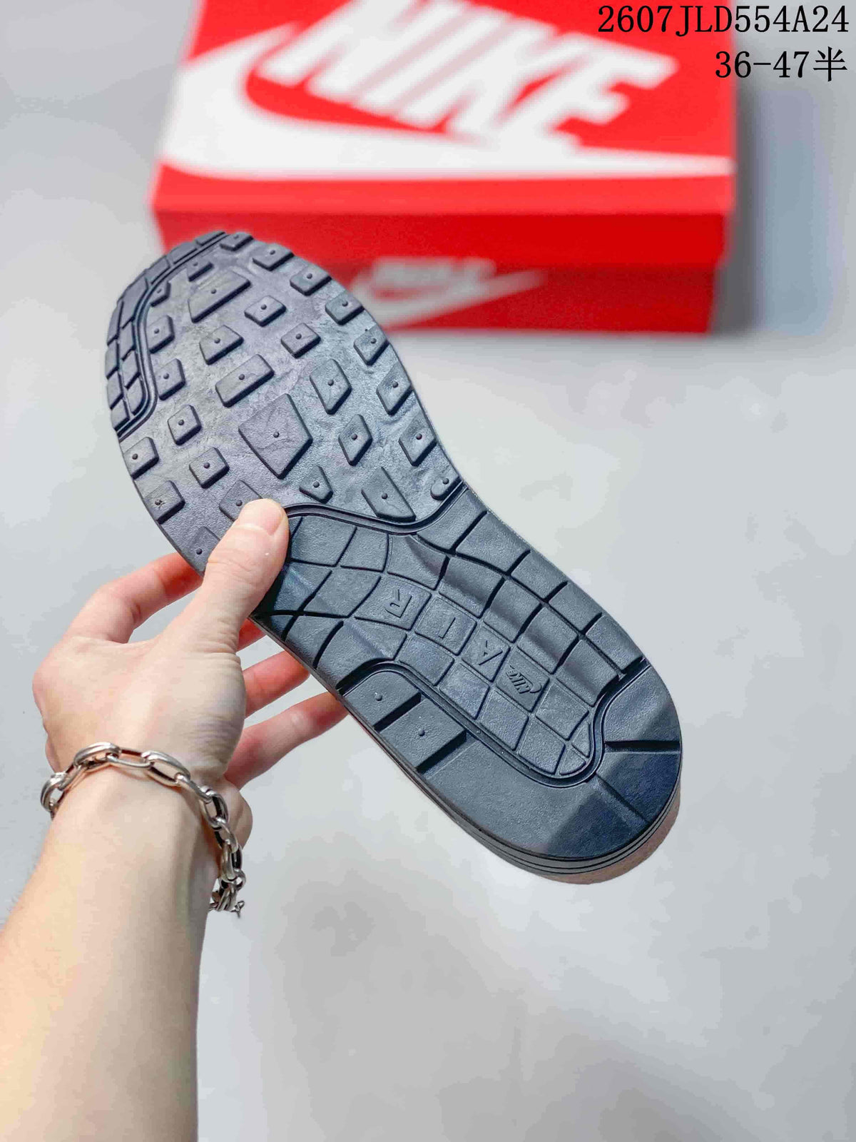 Black outsole of the Nike Air Max 1 sneaker showing its patterned tread.