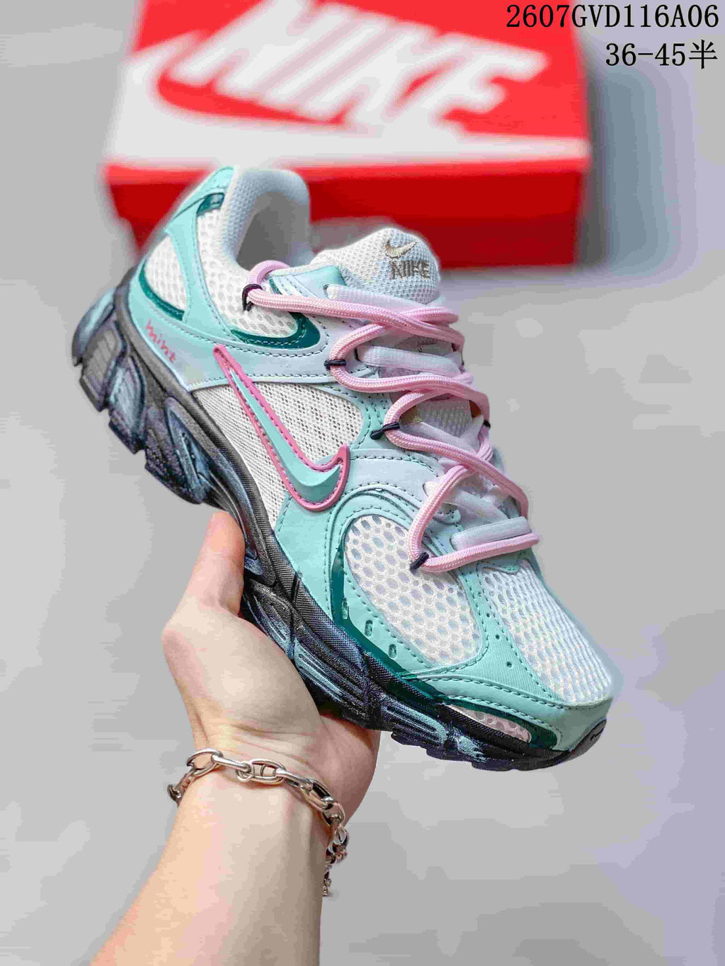 Angled side view of the Nike V5 RNR sneaker showing layered mint and white panels, pink laces, Nike branding and the dark outsole.