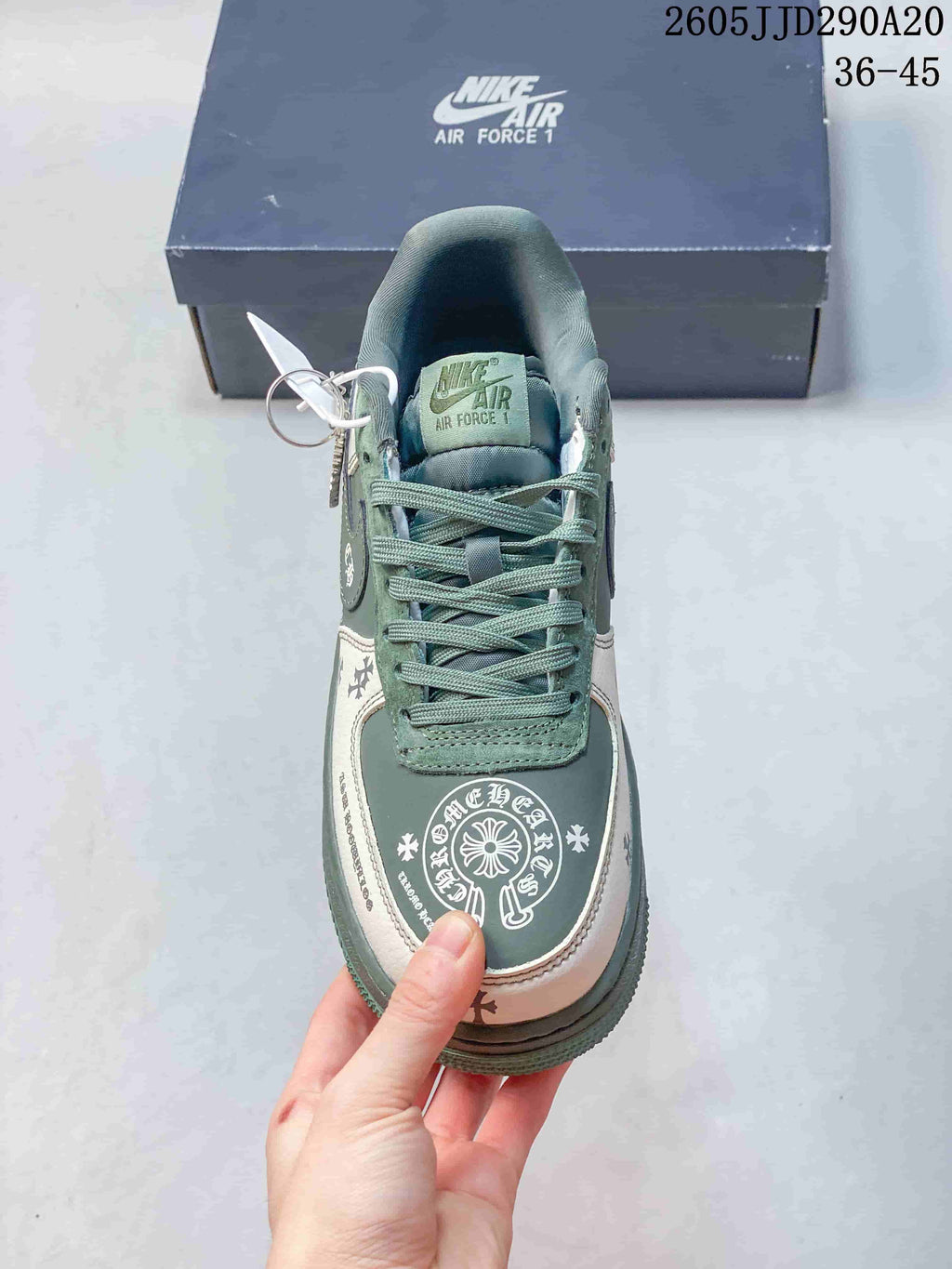 Top view showing the green tongue and laces, white-and-green toe area, and decorative circular graphic.