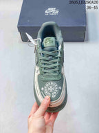 Top view showing the green tongue and laces, white-and-green toe area, and decorative circular graphic.