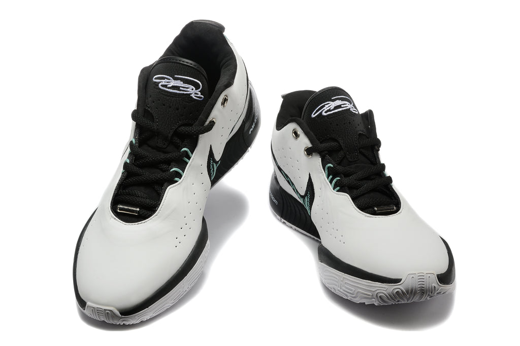 Front view of the white and black Nike sneakers with mint accents