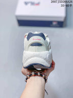 Rear view of the sneaker showing the padded heel, navy heel detail, FILA branding, and pink Études text.