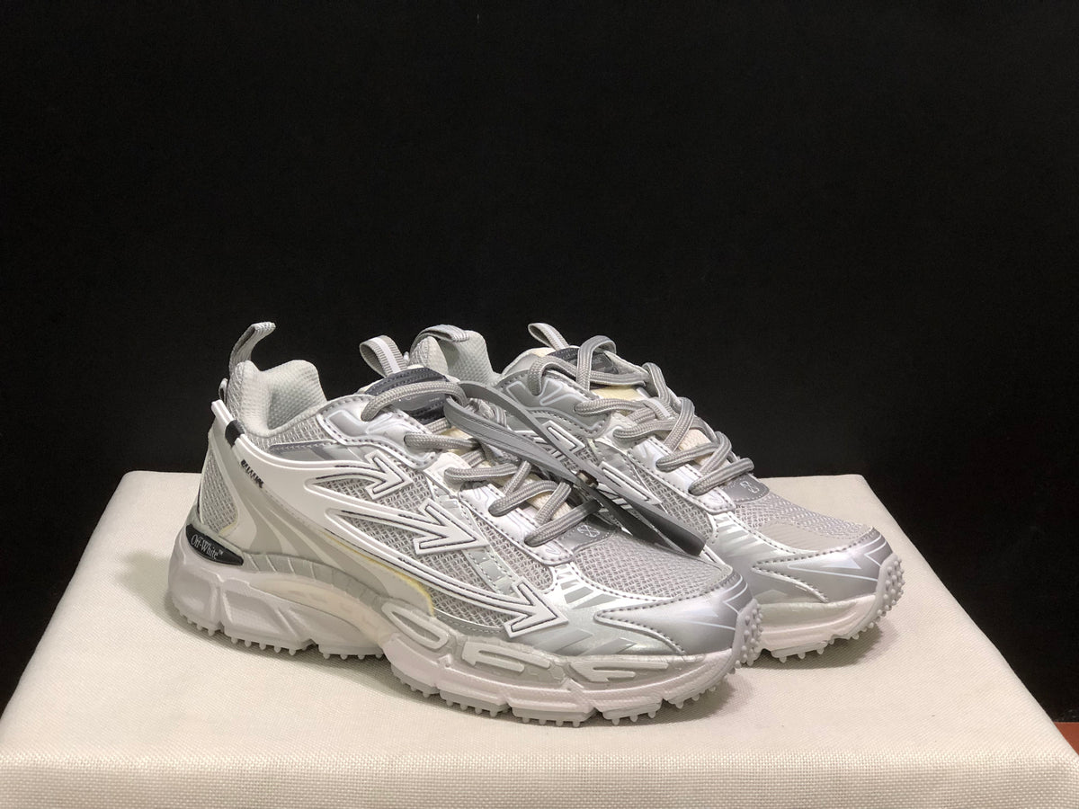 Front three-quarter product view showing the rounded toes, lace systems, mesh-like panels, and thick soles.