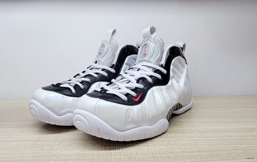 Front three-quarter view of cream-white Nike Air Foamposite Pro high-top basketball shoes