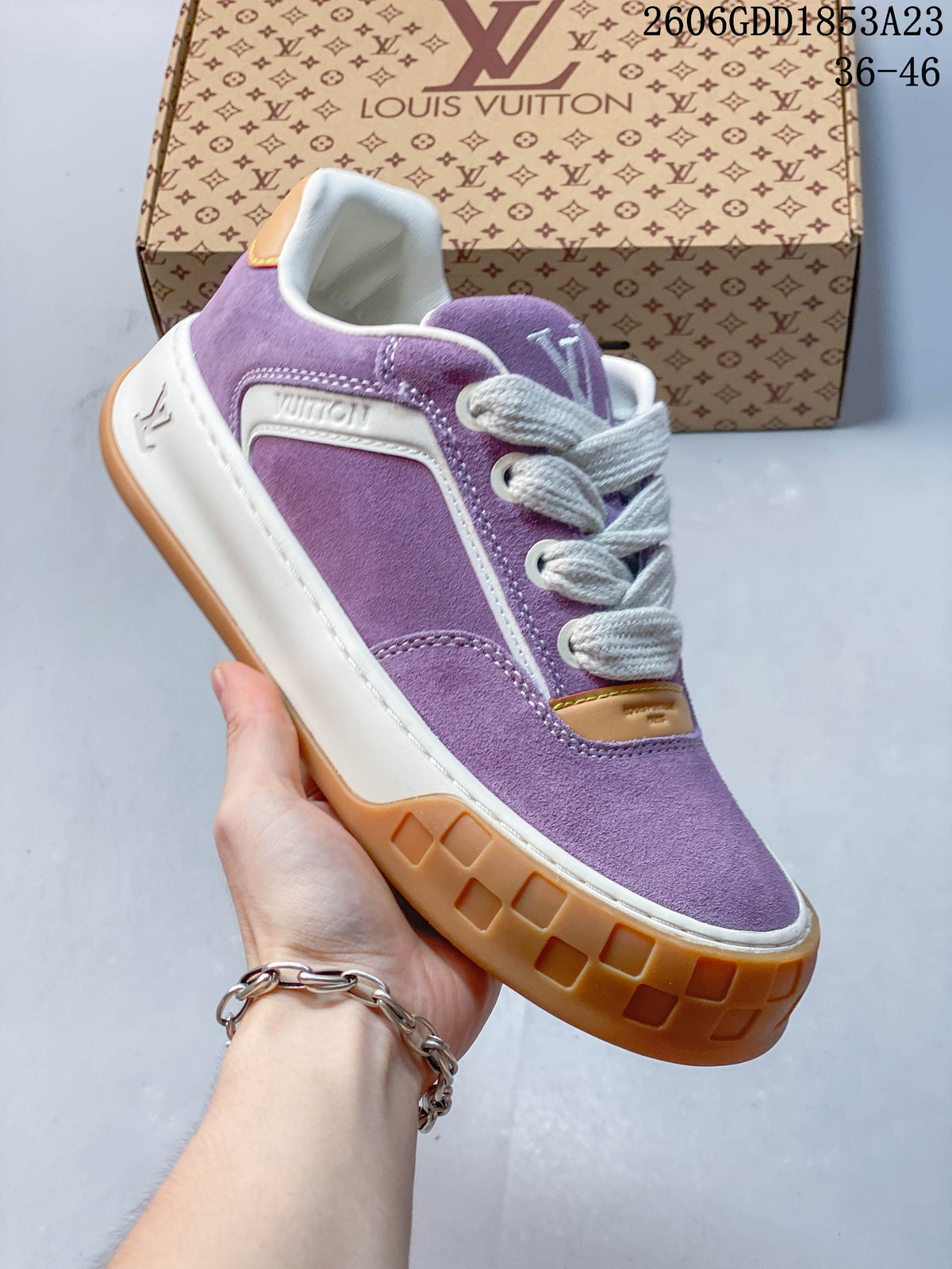 Angled side view highlighting the purple upper, white trim, and gum-colored outsole.