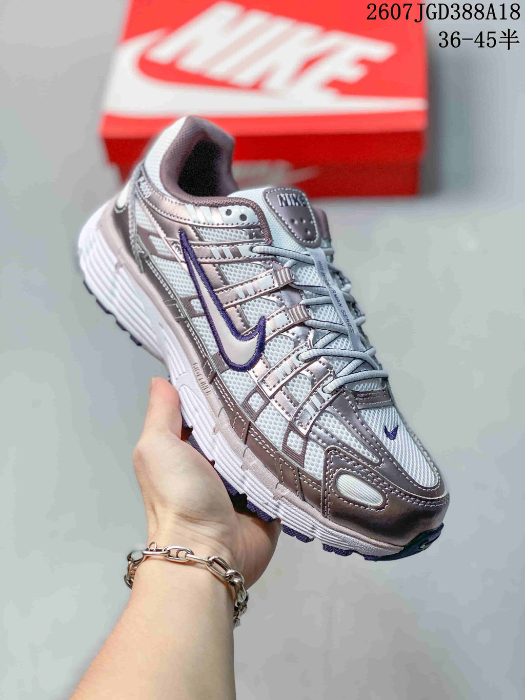 Angled side view of a Nike P-6000 sneaker in white, purple and pink with layered panels and a dark segmented outsole.