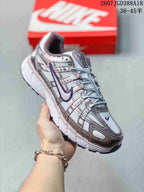 Angled side view of a Nike P-6000 sneaker in white, purple and pink with layered panels and a dark segmented outsole.