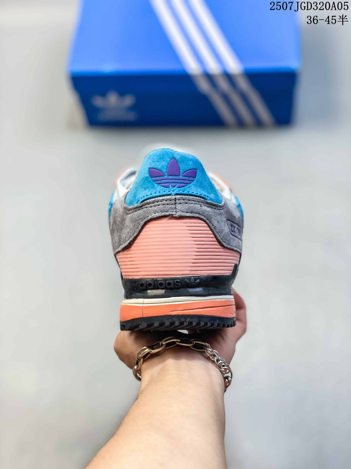 Rear view of an adidas ZX 750 sneaker showing blue and coral heel accents.