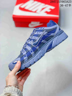 Side profile showing the layered upper, Swoosh branding, and structured outsole