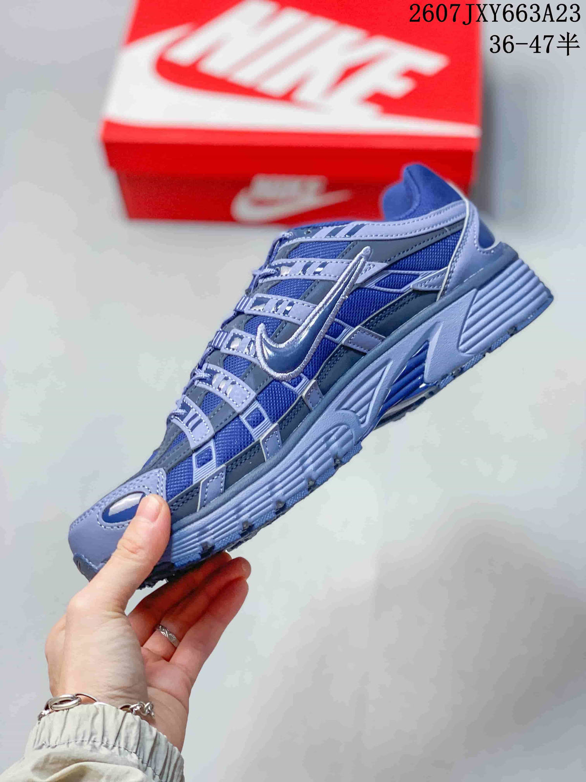 Side profile showing the layered upper, Swoosh branding, and structured outsole