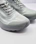 Close-up of the gray textured toe box, flat laces, tongue, and Alo logo.