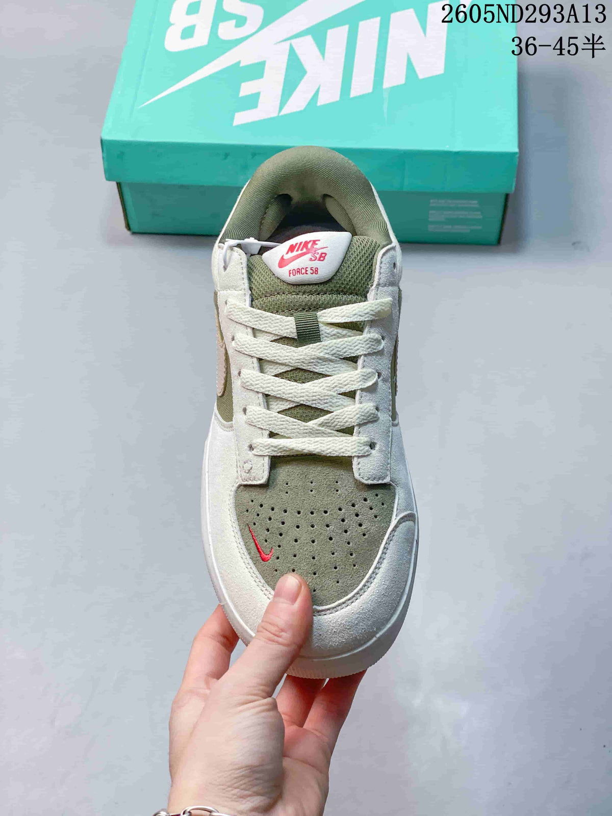 Top view showing the laces, perforated muted green toe panel, and padded tongue.