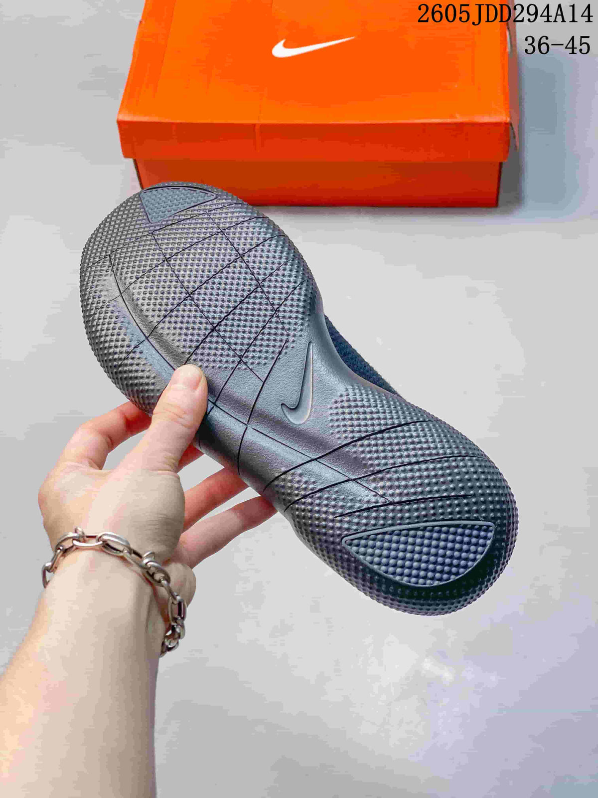 Close-up of the textured outsole and segmented groove pattern on a dark gray Nike Free sneaker.
