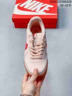 Top view of the lace-up sneaker showing the padded collar, tongue and pale pink upper.