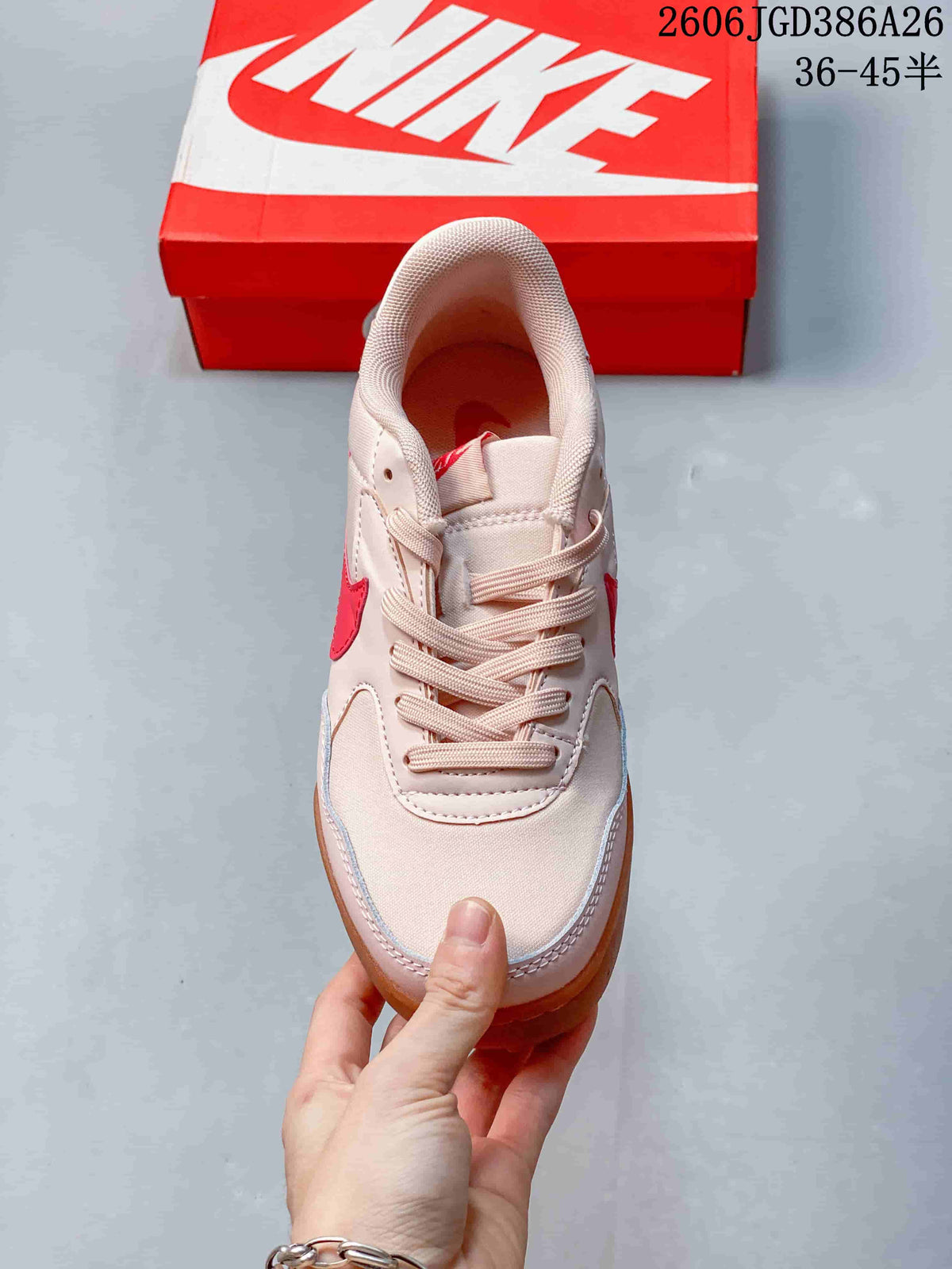 Top view of the lace-up sneaker showing the padded collar, tongue and pale pink upper.