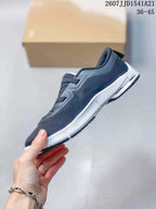 Side profile of a dark navy sneaker with layered lacing, white midsole and black outsole sections.