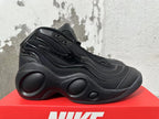 Side profile of a black Nike sneaker with molded side panels and a sculpted sole.