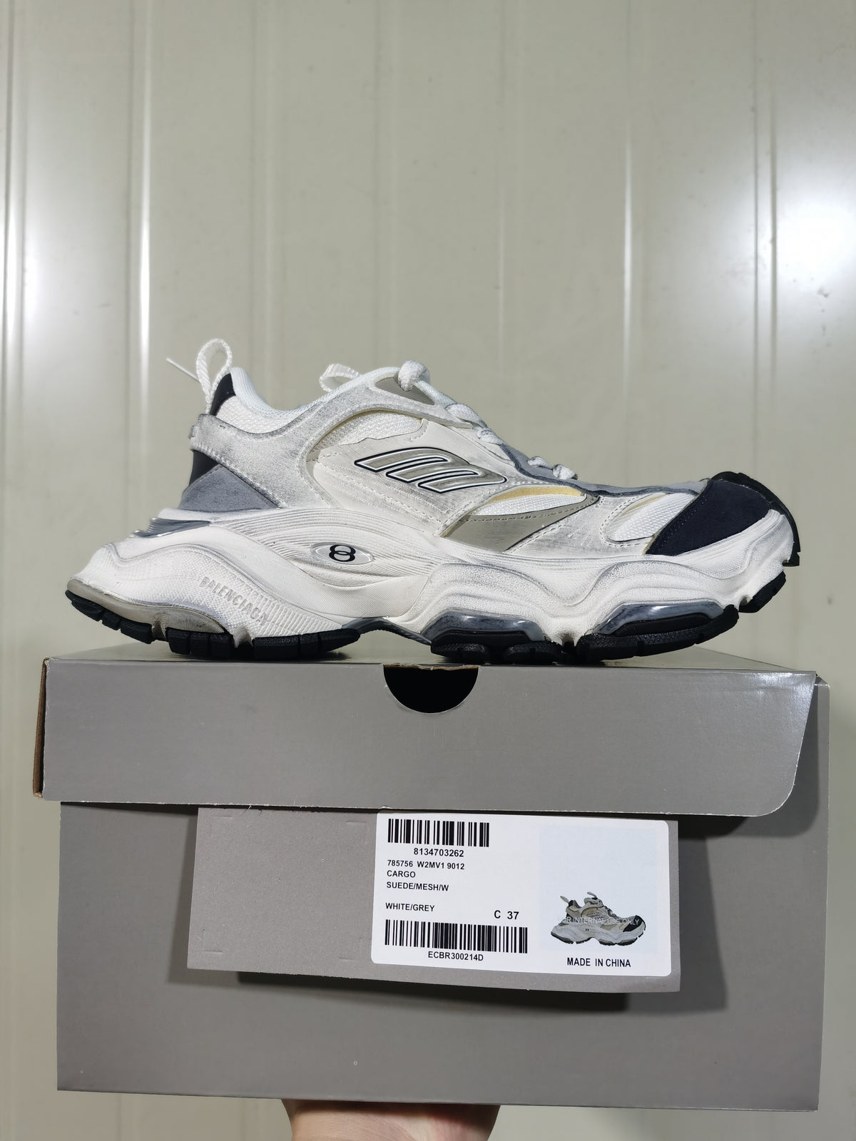 White and grey Balenciaga cargo sneaker displayed on its box; the box label shows WHITE/GREY and C 37.