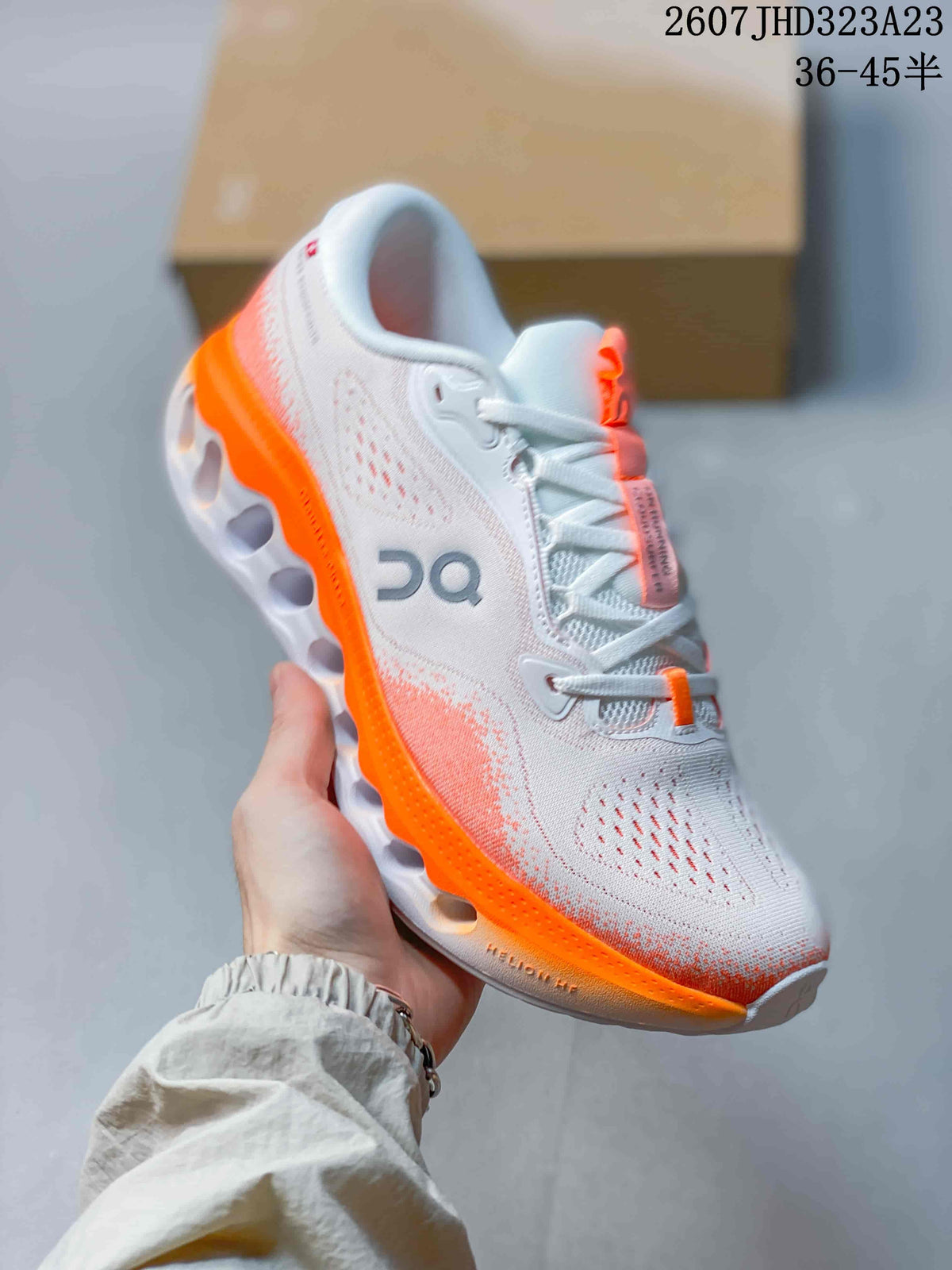 Angled side view of the sneaker showing the white upper, orange outsole, perforations, and On branding.