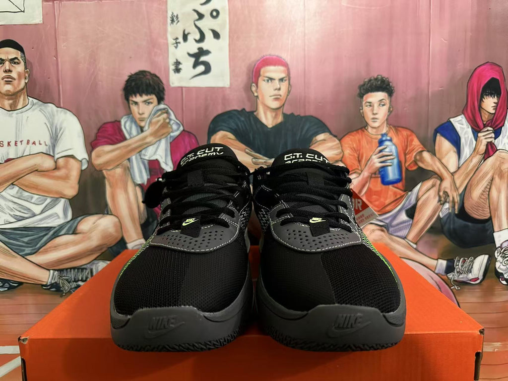 Front view of black Nike GT Cut 3 basketball shoes showing gray perforated overlays, green details and lace-up closures.