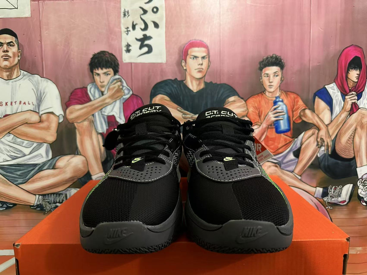 Front view of black Nike GT Cut 3 basketball shoes showing gray perforated overlays, green details and lace-up closures.