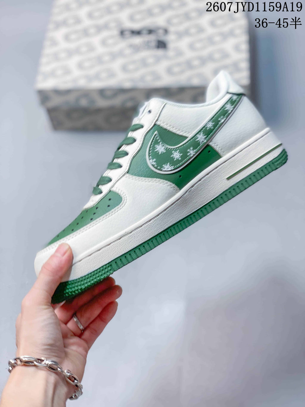 Side profile showing white and green panels, patterned side accents, low-top construction, and green outsole.