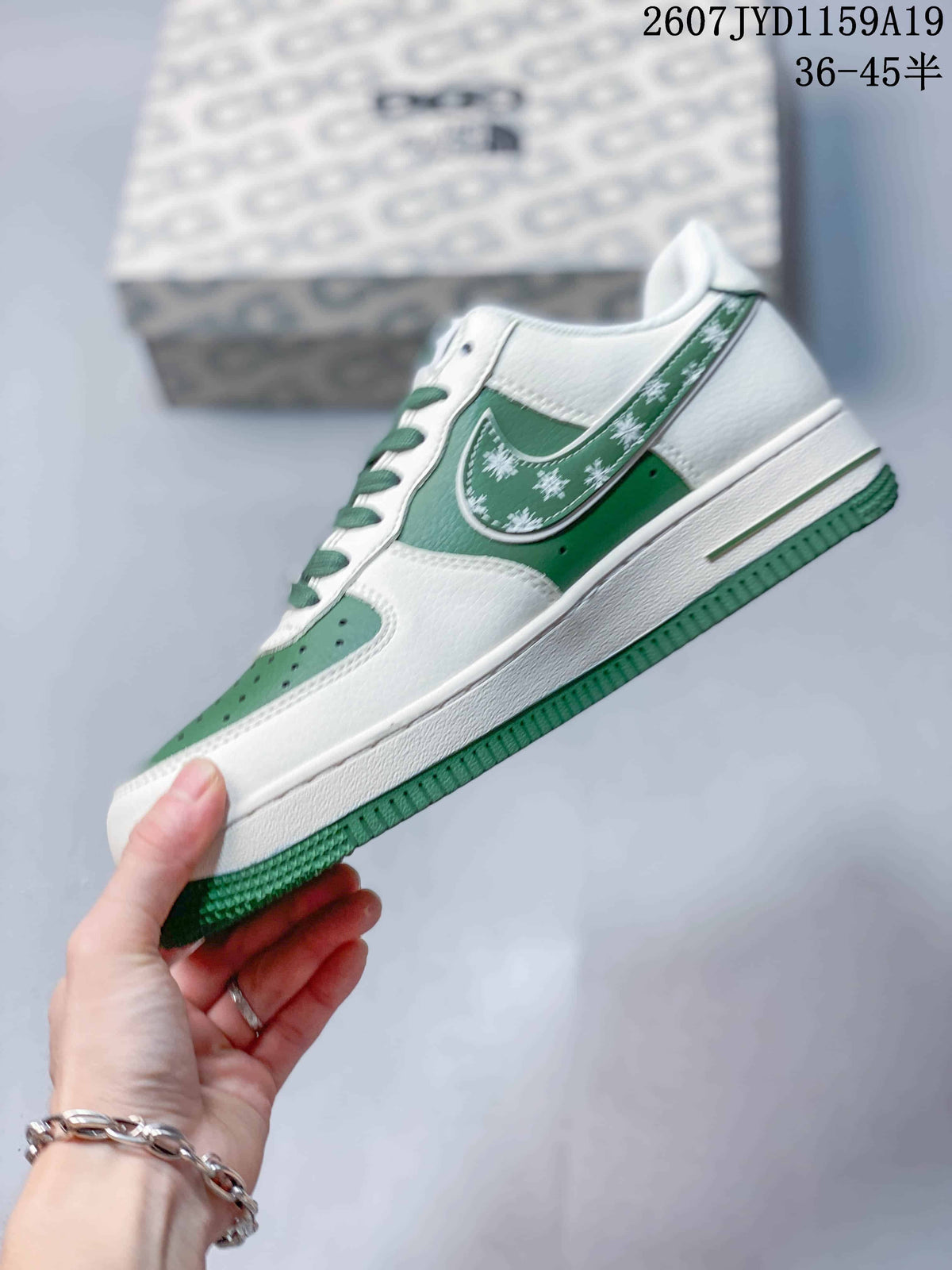 Side profile showing white and green panels, patterned side accents, low-top construction, and green outsole.